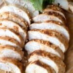 best baked chicken breast on a wood cutting board