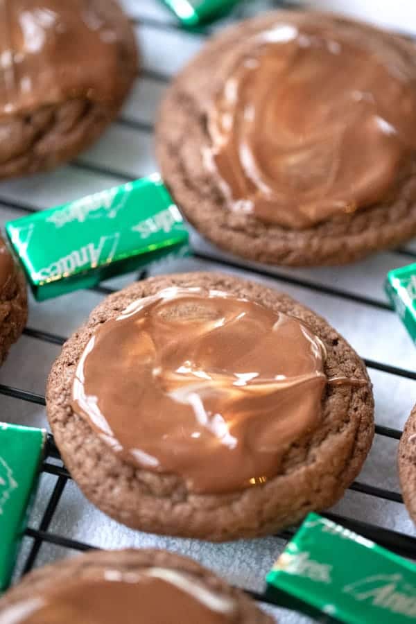 chocolate mint cookies with andes mints laying beside, andes candy cookies. fudgy chocolate mint cookies recipes. 