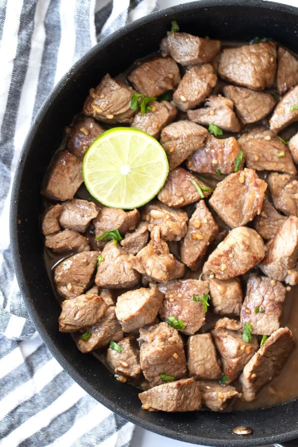 These chili lime steak bites with a lime wedge