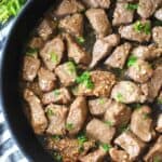 garlic butter steak bites in a pan with parsley