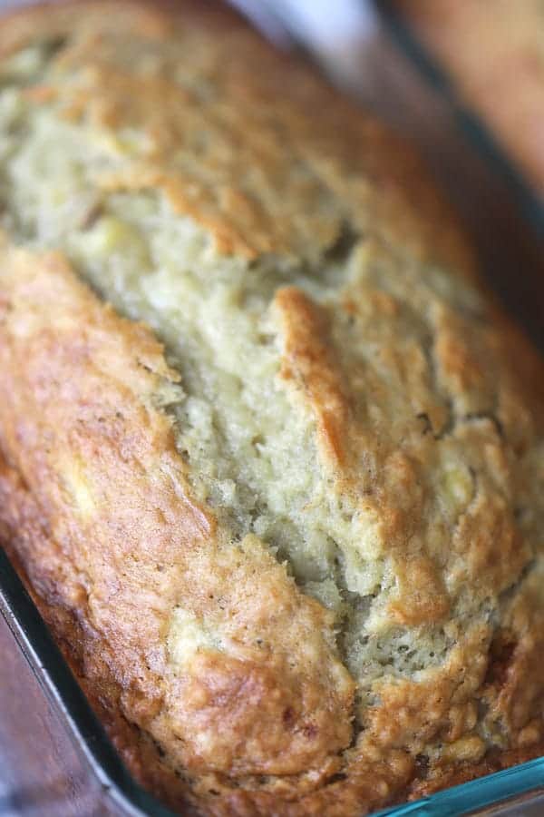 Homemade banana bread in a glass loaf pan.