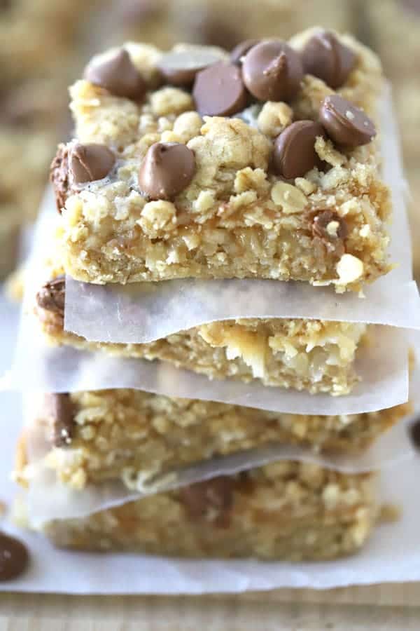 A stack of magic bars separated by small pieces of parchment paper.