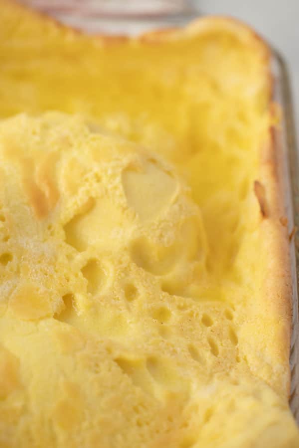 A large freshly baked German pancake in a glass baking dish.