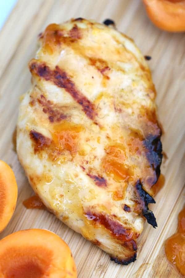 easy apricot chicken on a wood cutting board