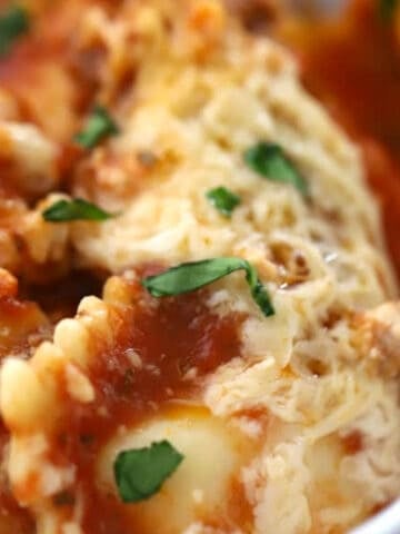 crockpot lasagna with ravioli- in a large white bowl, ravioli lasagna crockpot recipe.