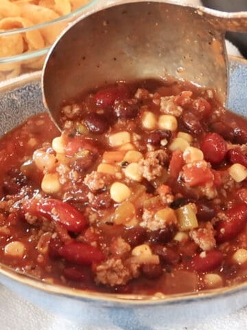 simple taco soup being scooped into a blue bowl