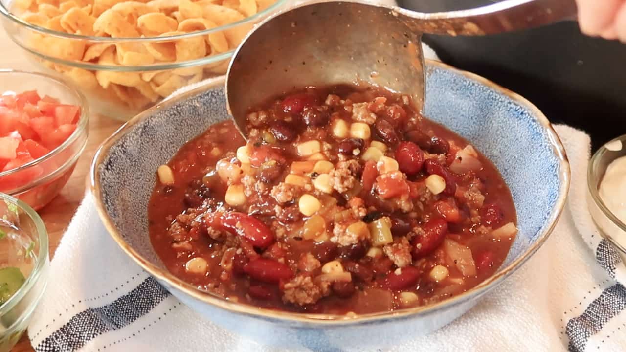 simple taco soup being scooped into a blue bowl