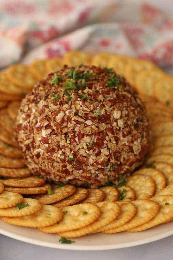 Ham and Cheddar Cheese Ball on a serving tray with Ritz Crackers.