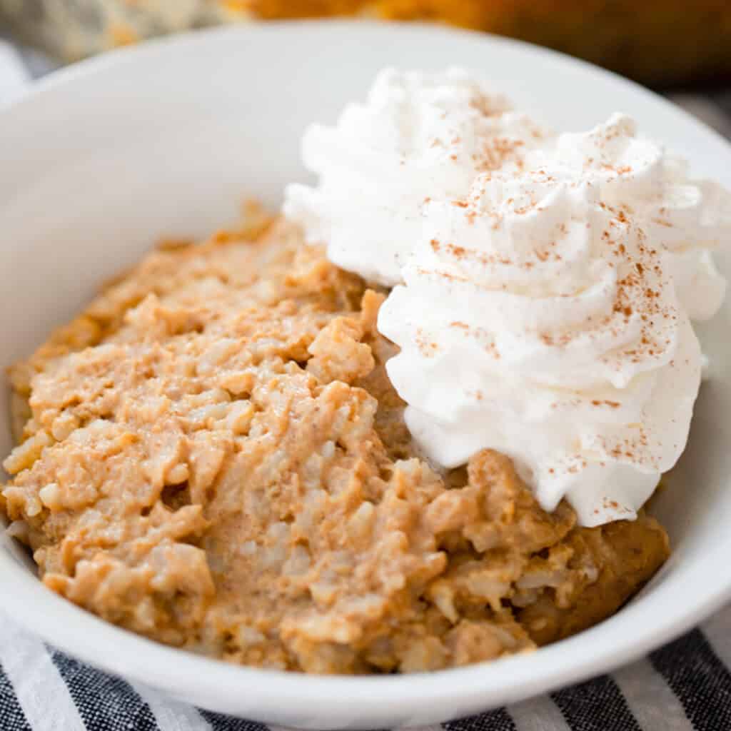 Baked pumpkin rice pudding in a ramekin.