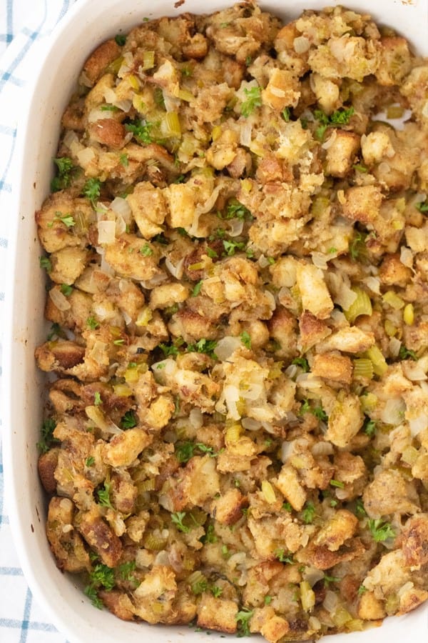 Grandma's Thanksgiving Stuffing baked in a white baking dish.