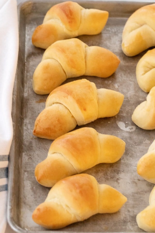 Crescent rolls on a baking sheet that were made using the best homemade crescent roll recipe.
