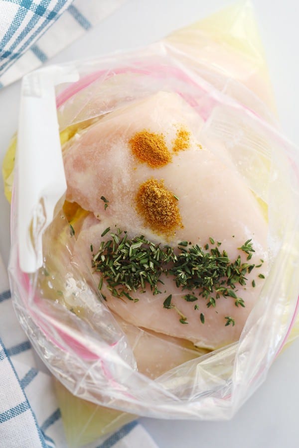 Chicken breasts in a freezer bag ready to marinate before making this easy baked lemon chicken breast recipe. It's a delicious lemon chicken recipe that's great for meal prep.