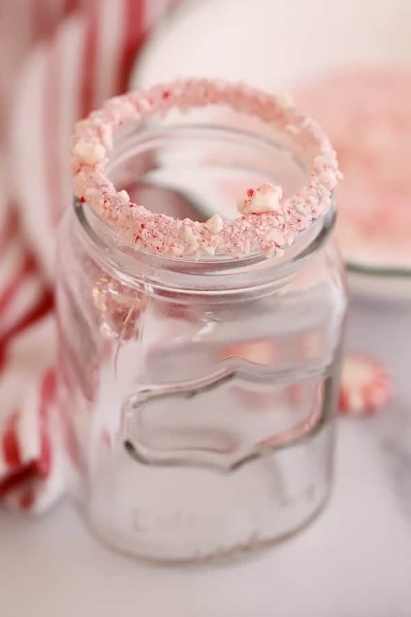 Crushed peppermint on the rim of a mason jar.