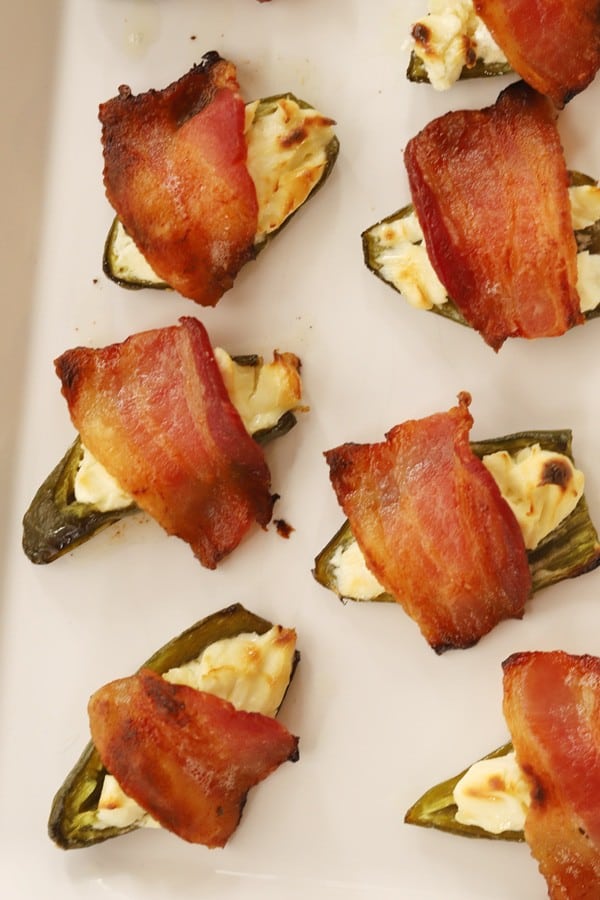 Cream cheese stuffed jalapenos topped with bacon.