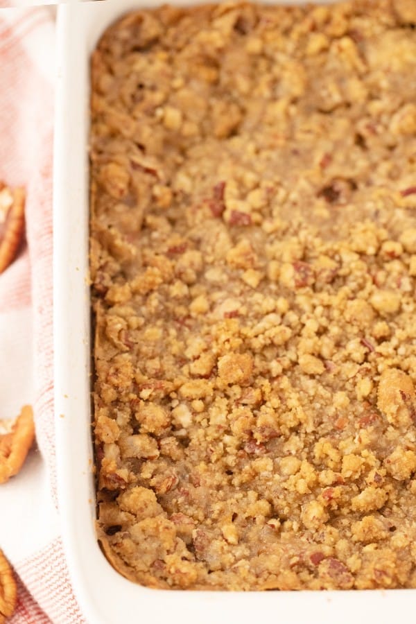 Pecan crumble topping over the top of a casserole in a baking dish.