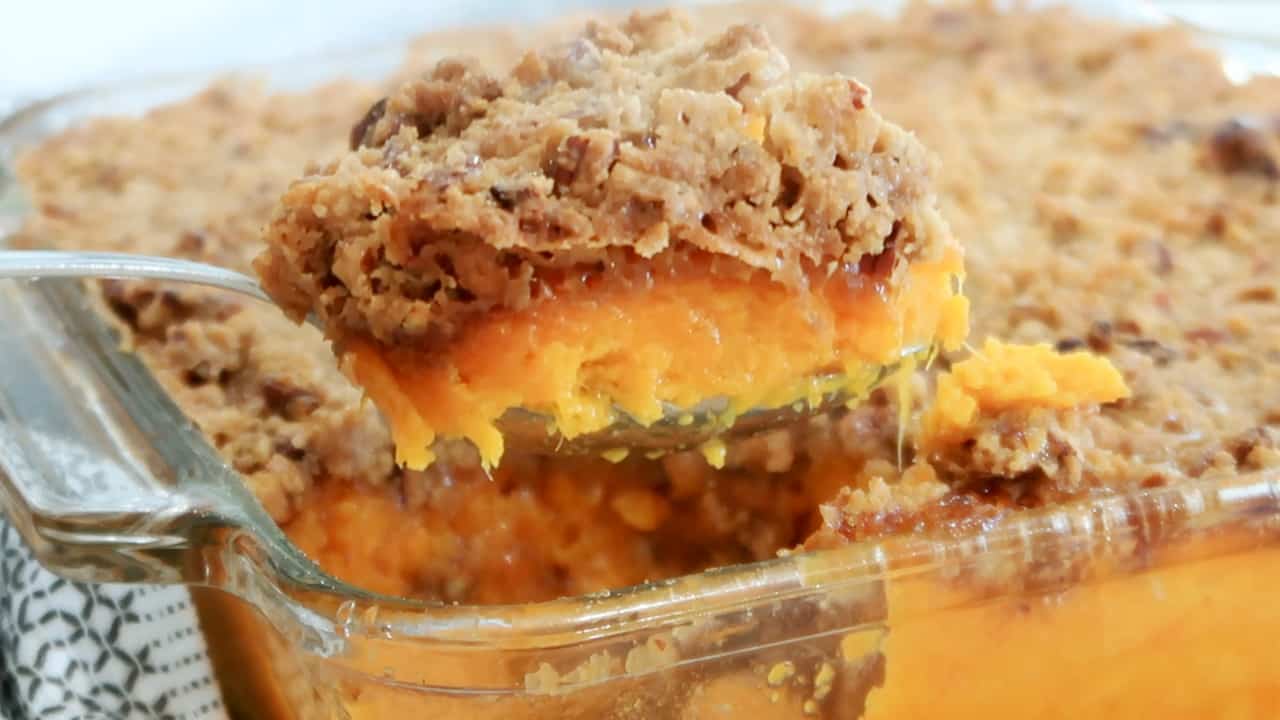 a big scoop of sweet potato casserole with pecan crumble topping