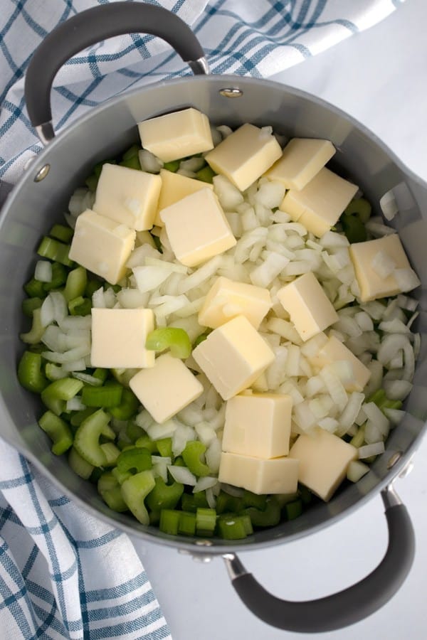 onions, celery and butter in a pan ready to make apple stuffing