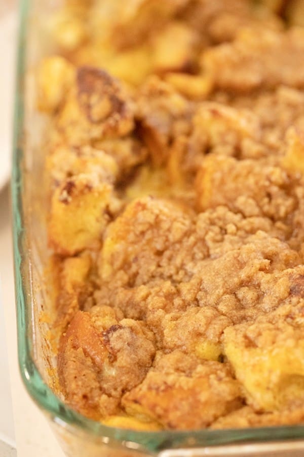 Apple french toast casserole in a baking dish with a buttery streusel topping.