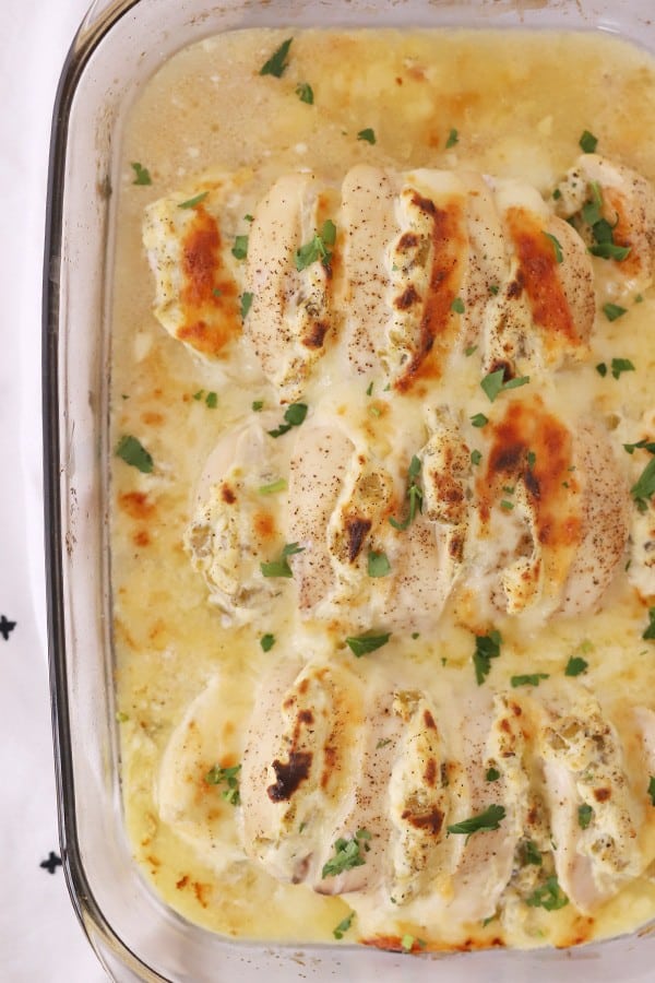A baking dish filled with cooked jalapeno popper chicken breast, an easy hasselback chicken recipe.