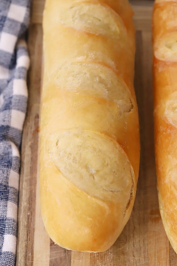 Golden French Bread on a cutting board, classic french bread recipe. 