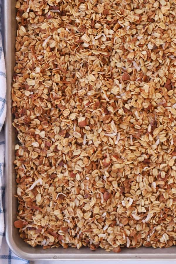 raw granola spread onto a baking sheet