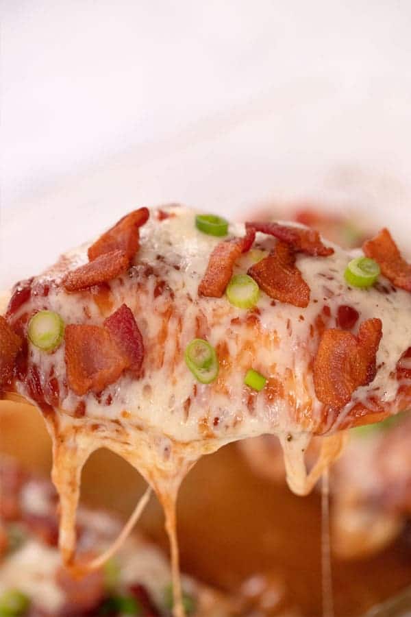 chicken breast bbq oven,  covered with melted cheese, bacon and scallions