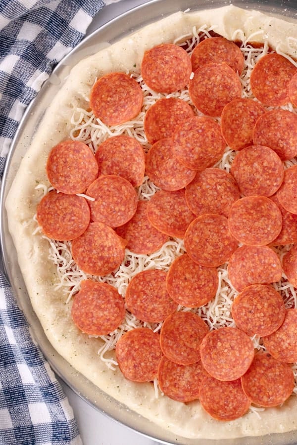 Uncooked Cheese Stuffed Crust Pizza Dough with pepperoni on top, how to make a stuffed crust pizza.