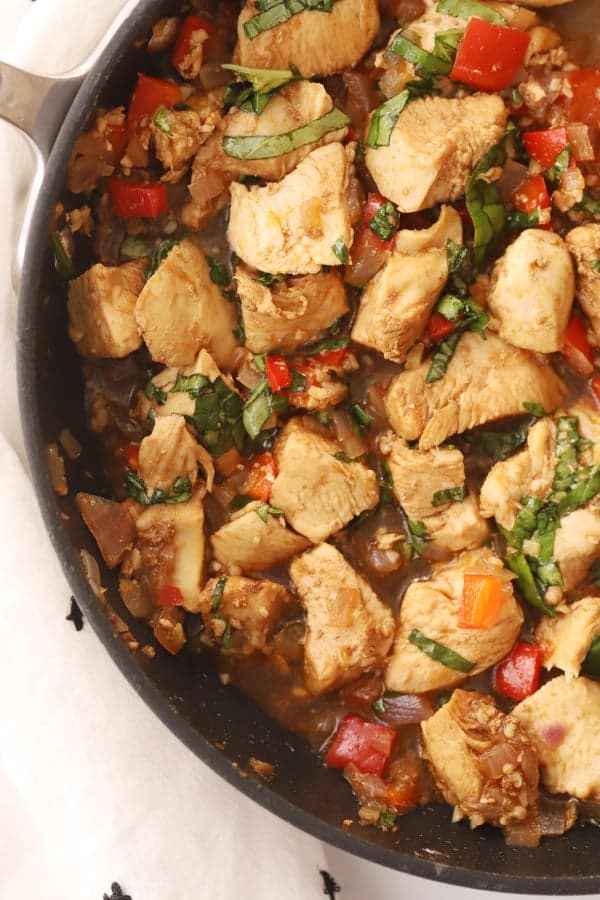 thai basil chicken stir fry in a pan, a delicious stir fry chicken with basil that tastes like it came from your favorite thai restaurant.