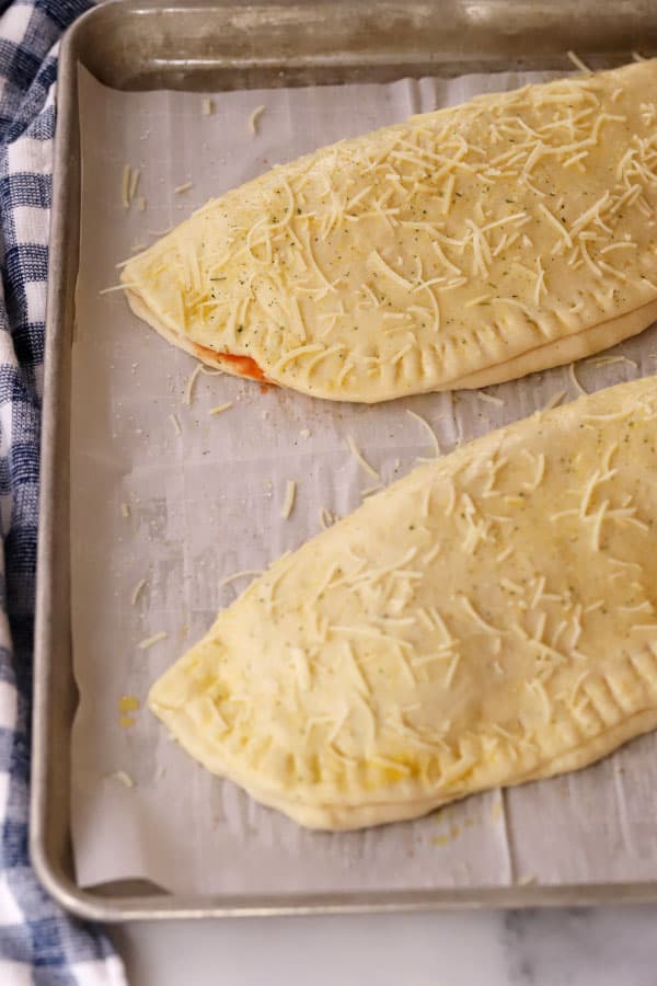 calzones on a baking sheet