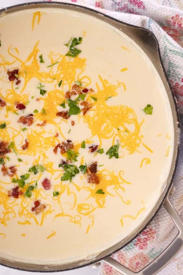 creamed Cauliflower soup with cheese, bacon and green onions on top