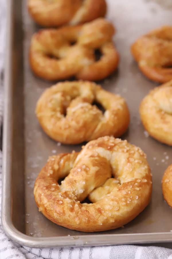 homemade soft pretzels on a baking sheet, easy soft pretzel recipe, soft pretzel bites, pretzel salted.