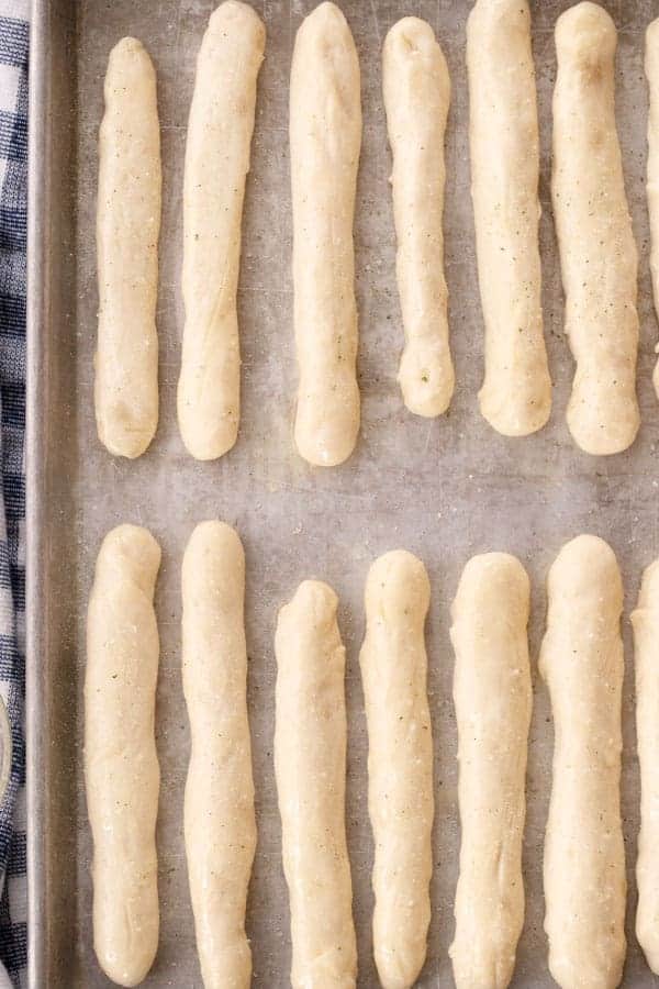 uncooked copy cat olive garden breadsticks on a baking sheet