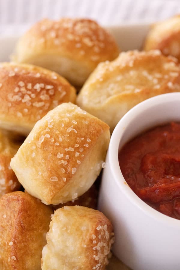 Soft pretzel bites with a side of marinara sauce.