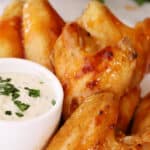 Buffalo chicken wings with a side bowl of ranch, how to bake chicken wings oven recipe.