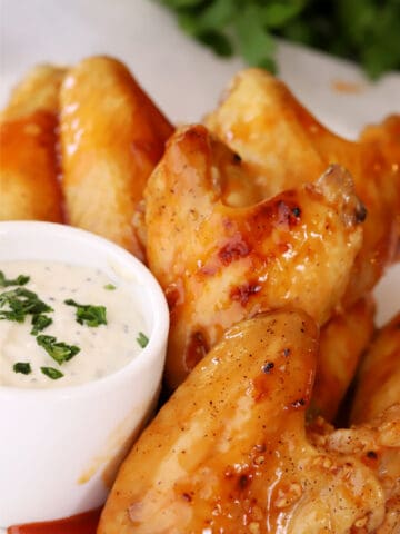Buffalo chicken wings with a side bowl of ranch.