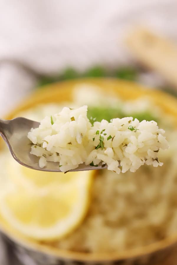 lemon herb rice on a fork, ready to eat.
