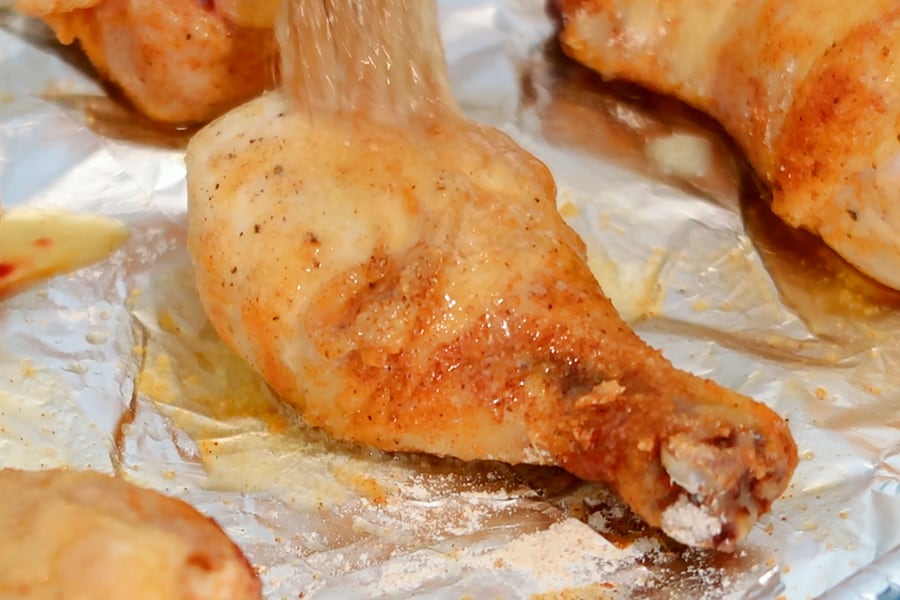 oven baked chicken drumstick on a baking sheet, chicken leg recipes easy.