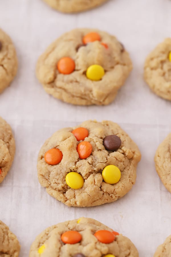 Reese's Pieces Cookies on a parchment lined baking tray.