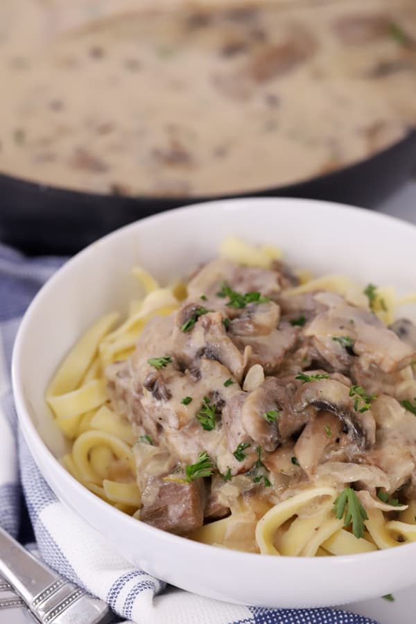 A bowl of old fashioned beef stroganoff served over egg noodles, a class stroganoff recipe.