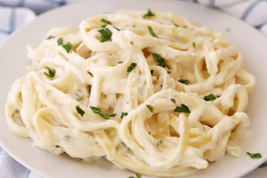 Homemade fettuccini Alfredo on a plate for dinner, alfredo sauce with cream cheese.