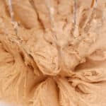 cinnamon butter cream frosting, light and fluffy in metal mixing bowl