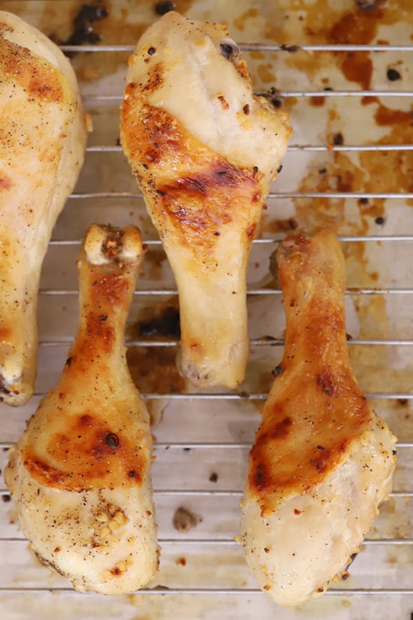 baked chicken legs on a cutting board