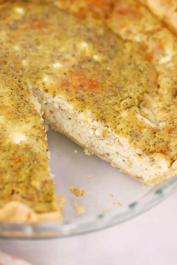 cut up homemade pesto quiche. types of quiche. pesto and eggs , egg pesto recipe. quiche sun dried tomato. cheese for pesto.
