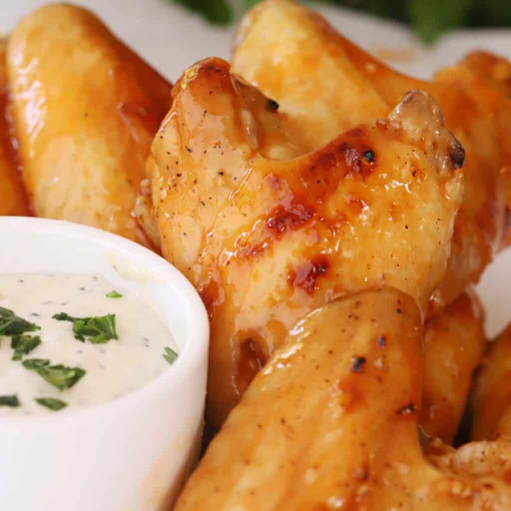 Buffalo chicken wings with a side bowl of ranch, baked buffalo chicken wings. 