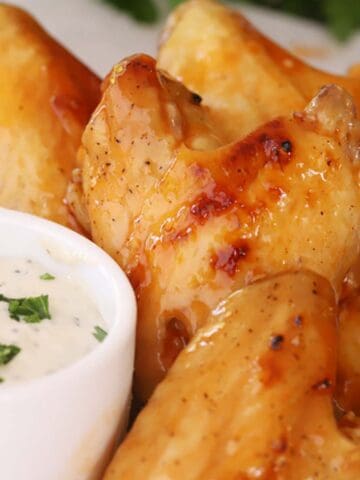 Buffalo chicken wings with a side bowl of ranch, how to bake chicken wings oven recipe. baked whole chicken wings. wing recipe baked.