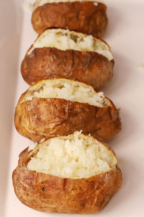 air fryer baked potatoes cooked and fluffed with a fork