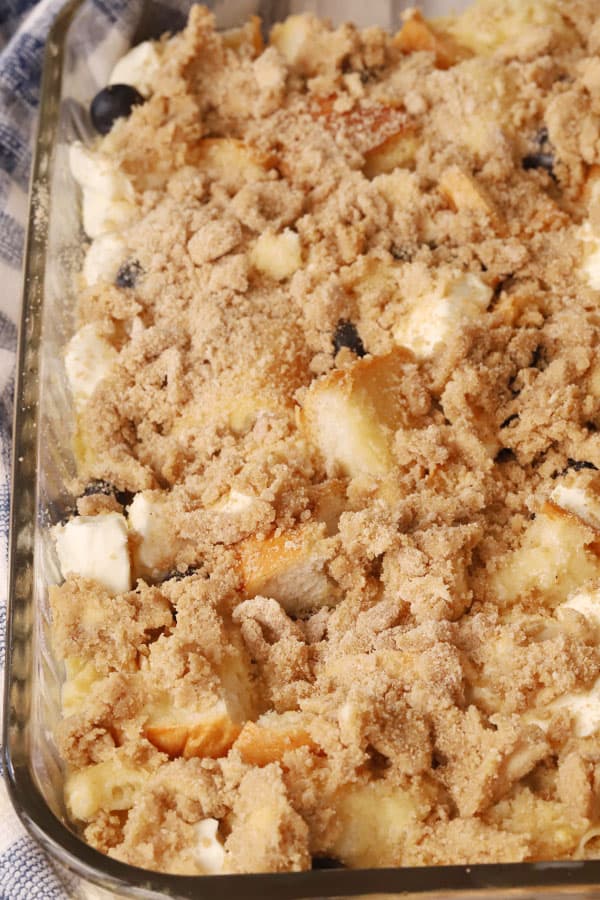 blueberry french toast casserole with streusel topping before baking, blueberry breakfast recipe. 