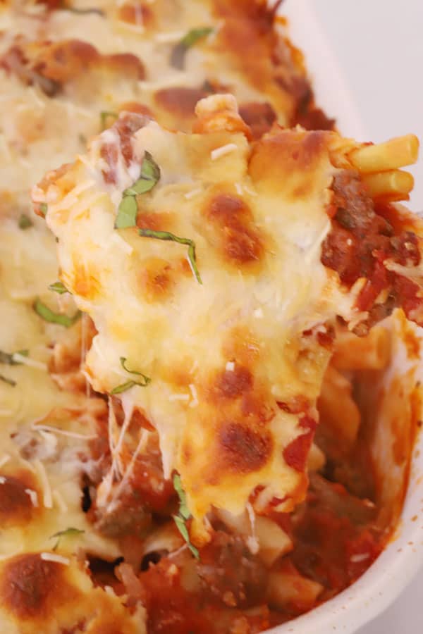 best baked ziti recipe being scooped out of a baking dish
