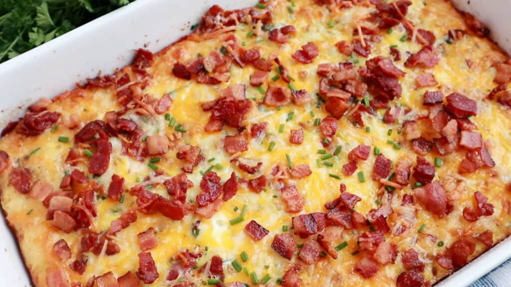 tater tot breakfast casserole recipe with bacon bits and cheese on top