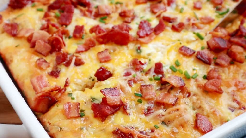 A tater tot breakfast casserole made with eggs and bacon bits. bacon buts or backn bits on top of casserole. recipe with bacon bits. 